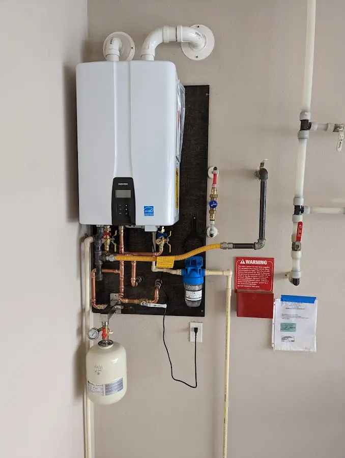 Professional plumber installing copper piping in a Wells home